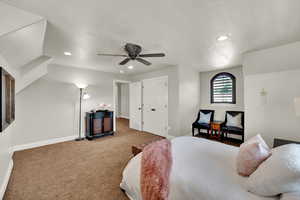 Carpeted bedroom with a textured ceiling, ceiling fan, recessed lighting, and a closet