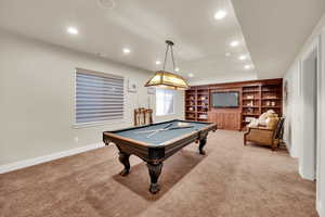 Playroom with billiards table, recessed lighting, light colored carpet, and built in shelves