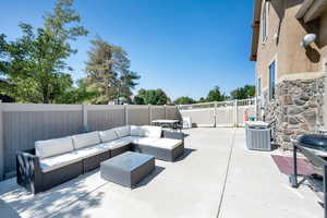 Fenced backyard with a patio, an outdoor living space, and grilling area