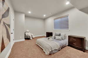 Bedroom with recessed lighting and light carpet