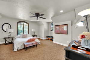 Bedroom featuring light colored carpet, ceiling fan, lofted ceiling, a textured ceiling, and recessed lighting