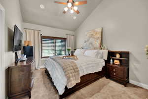 Bedroom with light carpet, a ceiling fan, a textured ceiling, and high vaulted ceiling