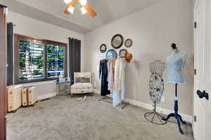 Sitting room with carpet flooring and a ceiling fan