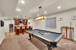 Rec room with light tile patterned floors, beverage cooler, recessed lighting, bar with sink, and billiards
