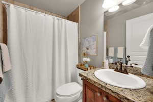 Full bath featuring vanity and a shower with curtain