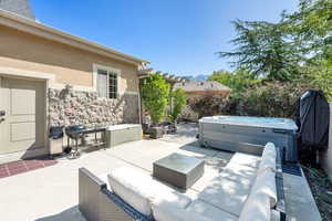 View of patio / terrace with an outdoor hangout area, a hot tub, and area for grilling