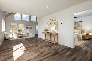Entrance foyer with recessed lighting, dark wood finished floors, and a towering ceiling (Virtually staged)