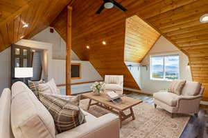Living area featuring wooden ceiling, wood finished floors, recessed lighting, and lofted ceiling (Virtually staged)