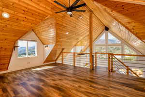 Bonus room with wood finished floors, wood ceiling, and a ceiling fan