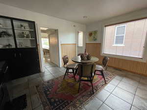 Dining area featuring a wainscoted wall and built in cabinets