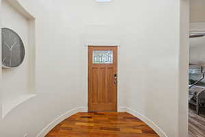 Foyer with hard wood flooring and baseboards