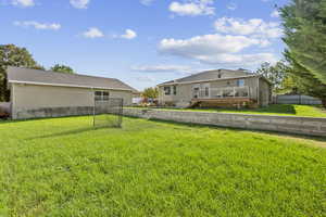 Large, fenced tiered back yard and separate six-car garage/workshop.
