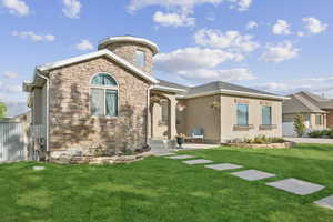 View of front of house featuring stone siding and stucco siding