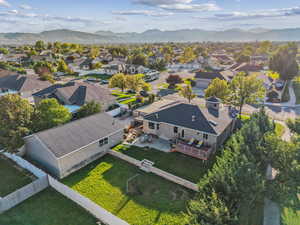 Aerial view of back of home and neighborhood.