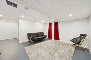 Bonus room with finished concrete flooring and recessed lighting