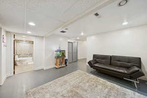 Bonus room with finished concrete flooring and recessed lighting