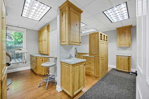 Procedure room a drop ceiling and light wood finished floors