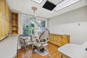 Procedure room a drop ceiling and light wood finished floors