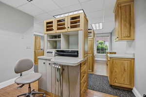 Procedure room a drop ceiling and light wood finished floors