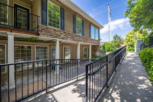 Doorway to property featuring stucco siding and stone siding