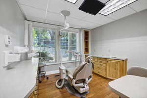 Procedure room a drop ceiling and light wood finished floors