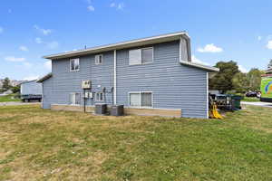 Rear view of house with yard