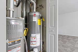 Utility room with gas water heater and heating unit