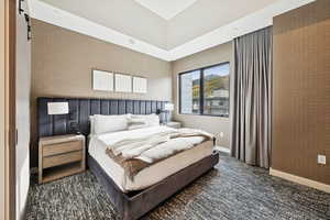Bedroom featuring dark carpet and a barn door