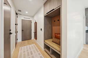 Mudroom featuring light wood-type flooring and recessed lighting