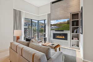 Living room featuring light wood finished floors and a fireplace