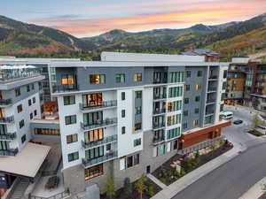 Property at dusk featuring a view of apartment building / complex and a mountain view