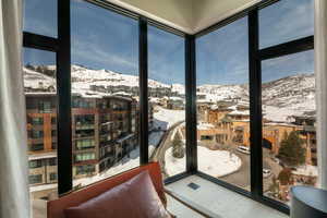 Doorway with a mountain view and wood finished floors
