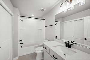 Full bathroom with washtub / shower combination, vanity, light tile patterned floors, and recessed lighting