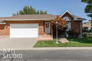 Ranch-style home featuring a shingled roof, brick siding, concrete driveway, and a garage