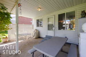 Porch with outdoor dining area, grilling area, and a patio area