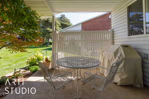 View of patio featuring a grill and outdoor dining area