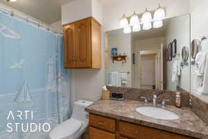 Full bath with vanity and a shower with shower curtain