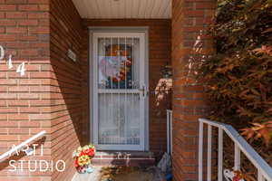 Entrance to property featuring brick siding