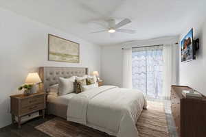 Carpeted bedroom featuring a ceiling fan