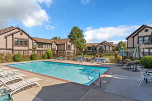 Community pool with a residential view and a patio