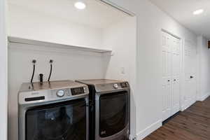 Laundry area with dark wood-style flooring, independent washer and dryer, and recessed lighting