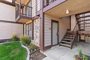 Entrance to property featuring a patio and stone siding