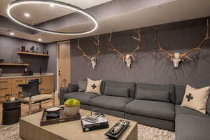 Living room with wet bar and wallpapered walls