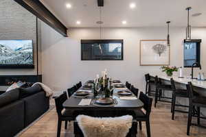 Dining room with wood finished floors and recessed lighting