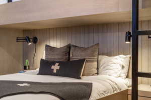 Bedroom with wood walls