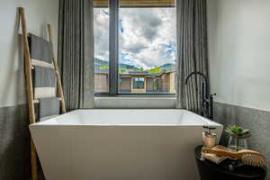 Full bathroom featuring a freestanding bath