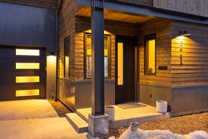 View of exterior entry with a garage and covered porch