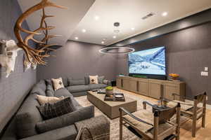 Cinema room featuring recessed lighting and light wood-style floors