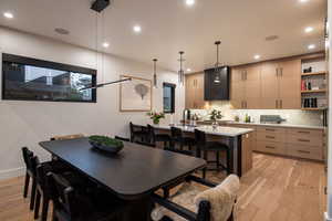 Dining room featuring light wood-type flooring and recessed lighting
