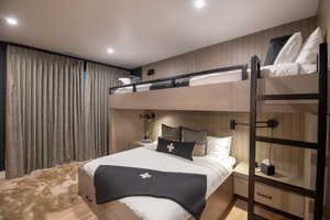 Bedroom with wood finished floors and recessed lighting